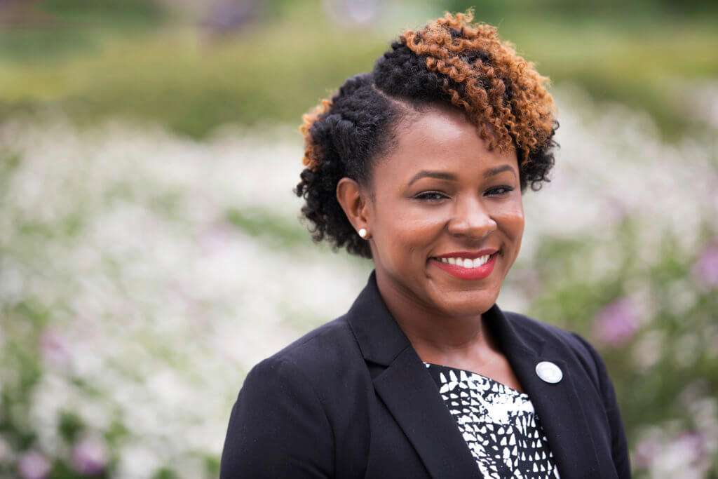 Black woman standing outside smiling 