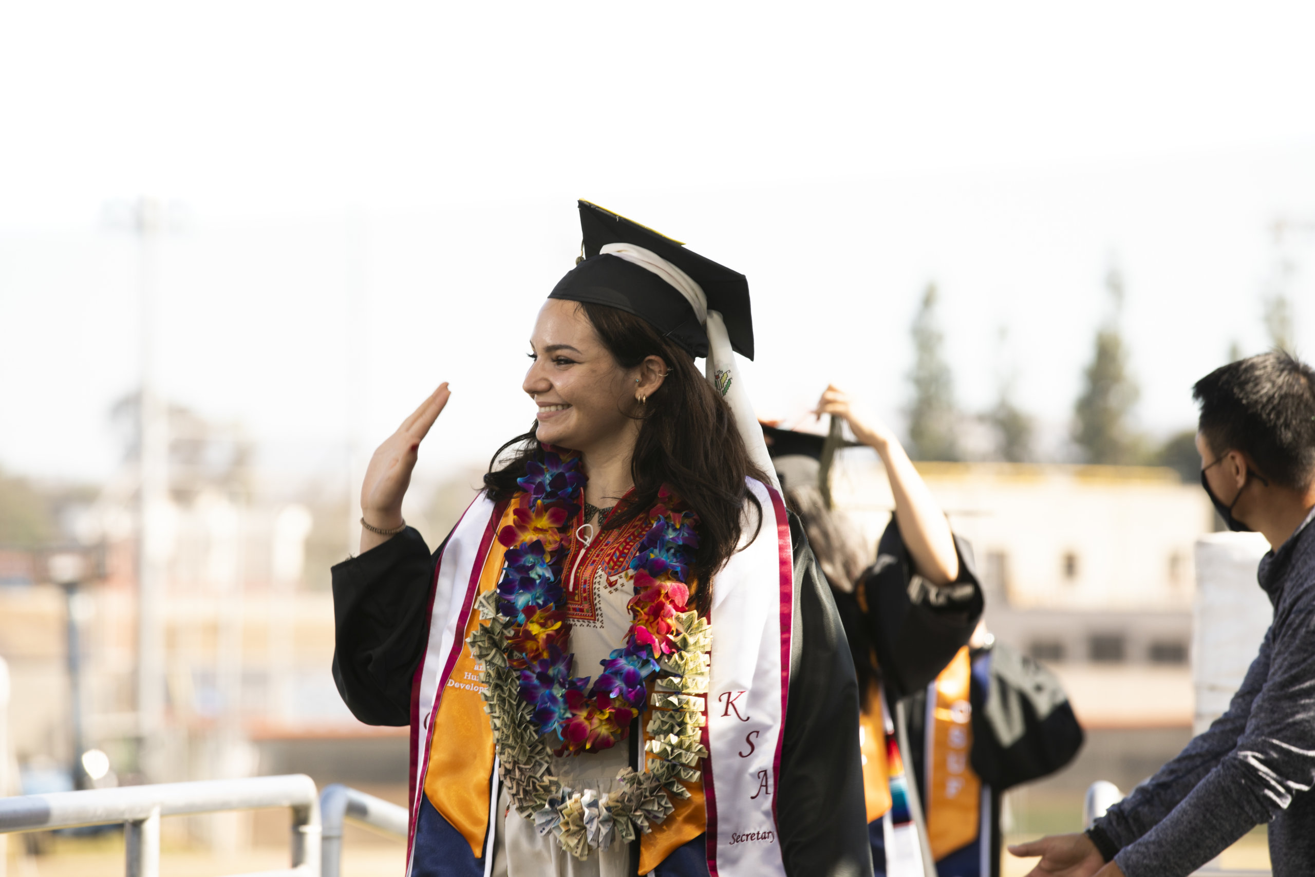 Graduate waves from Commencement stage