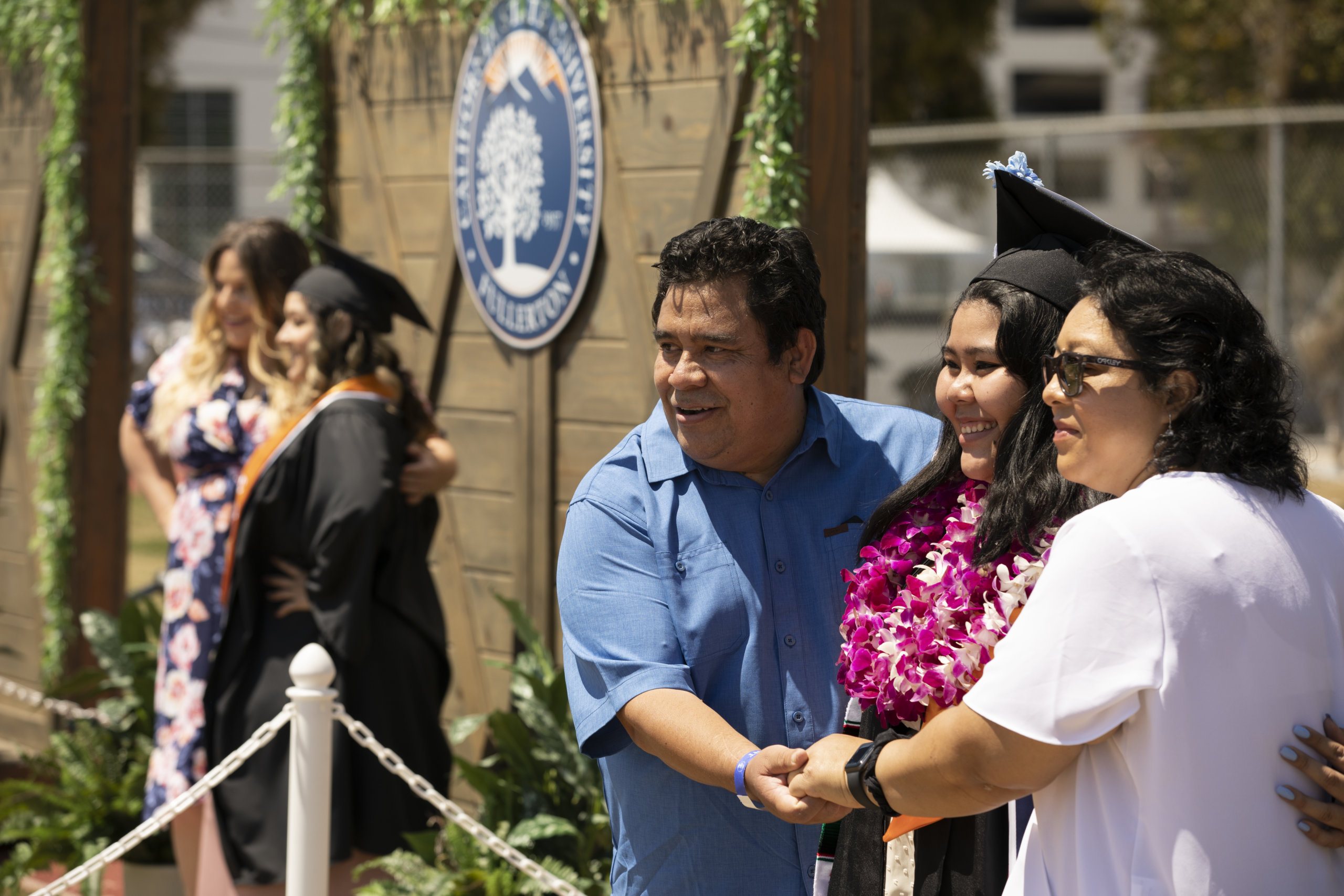 Graduate poses for family photo