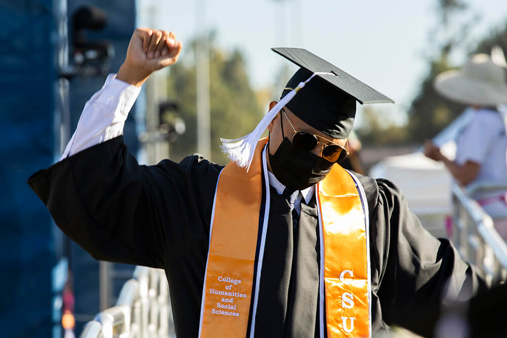 Graduate raises fist in air in celebration