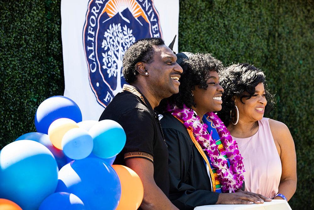 Family poses for photo with grad