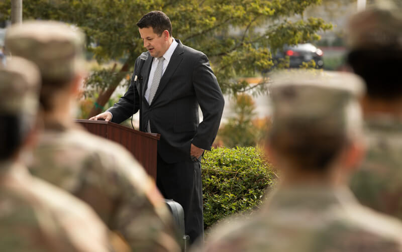 Cameron Cook flanked by ROTC Cadets