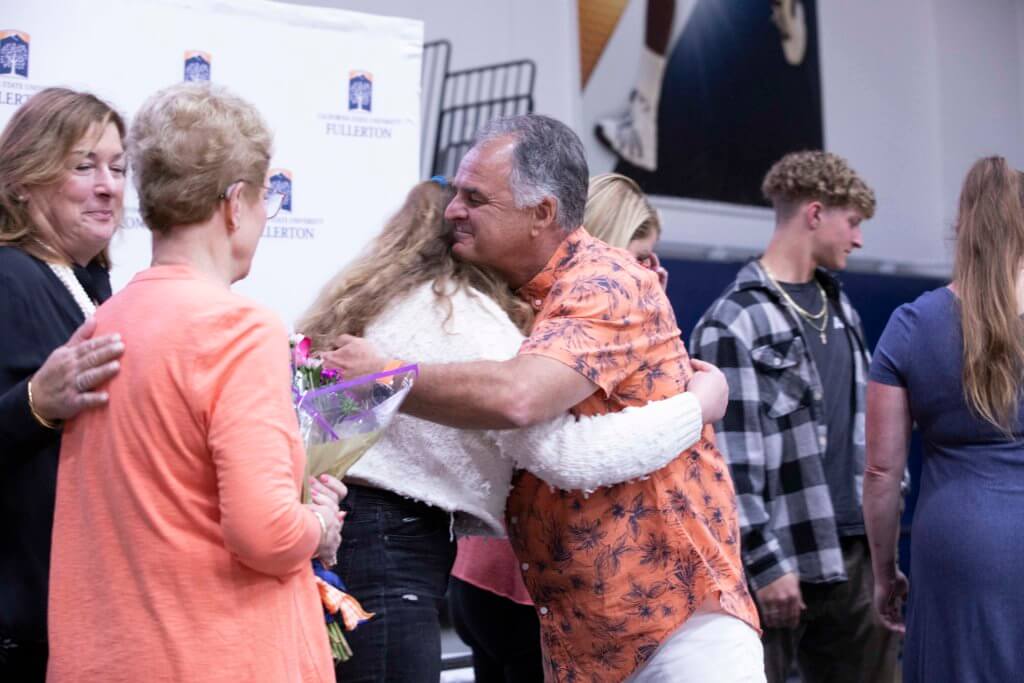 President Virjee hugs Bedell Family