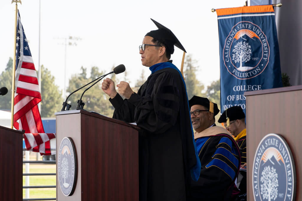 Charlie Zhang speaks at podium