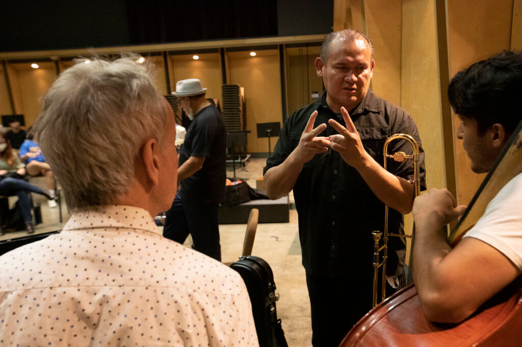 Francisco Torres, center, works with student Kevin Karagozian on bass, right, and Bill Cunliffe, left.