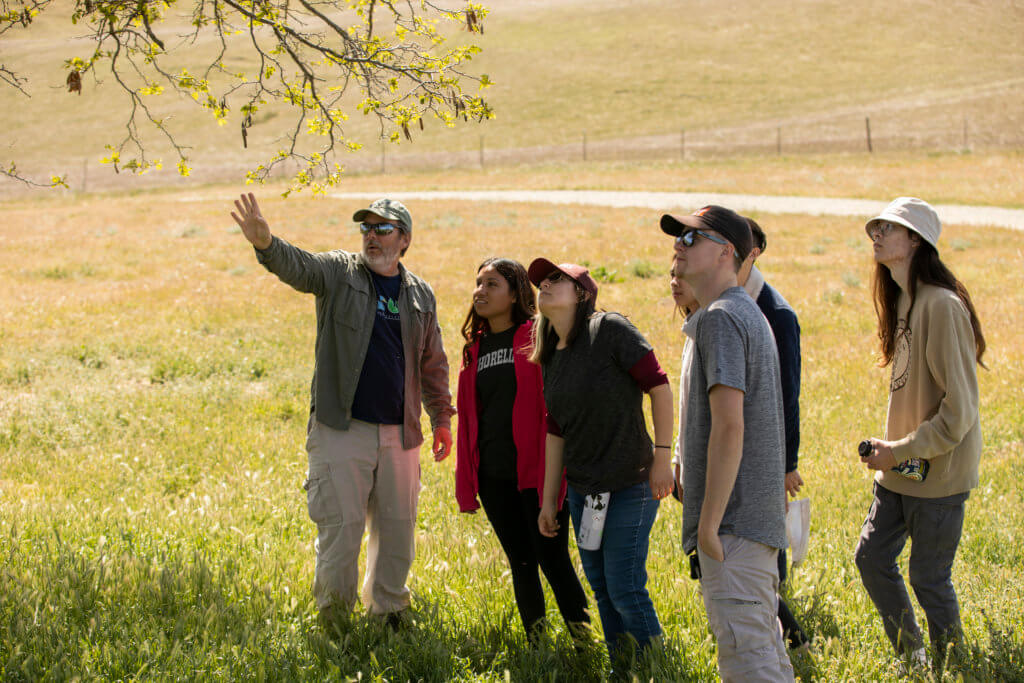 Bill Hoese leads Ornithology class in field.