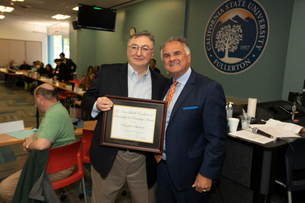 Outstanding Professfor Bogdan Suceava is congratulated by President Virjee