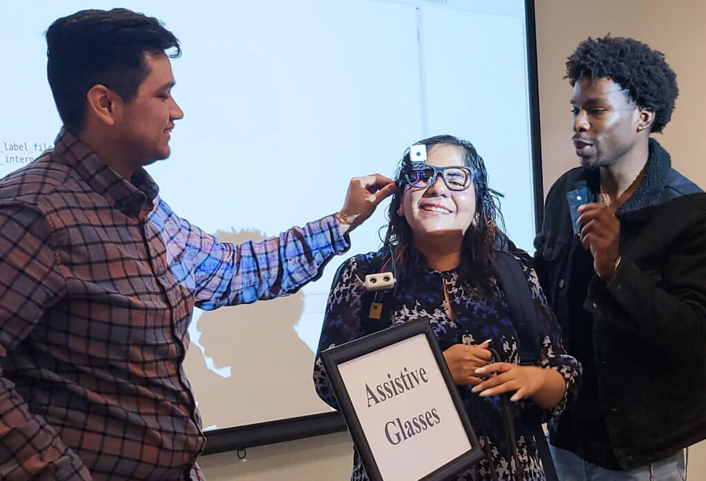 Student Rodney Nobles works with Juanita and Assistive Glasses