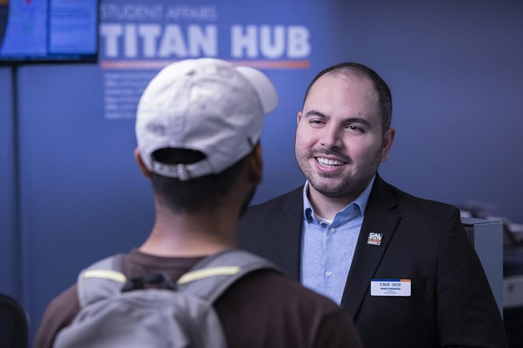 Marco Mendoza speaking with student at Titan Hub