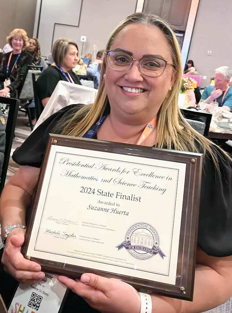 mathematics teacher suzanne huerta poses with presidential award