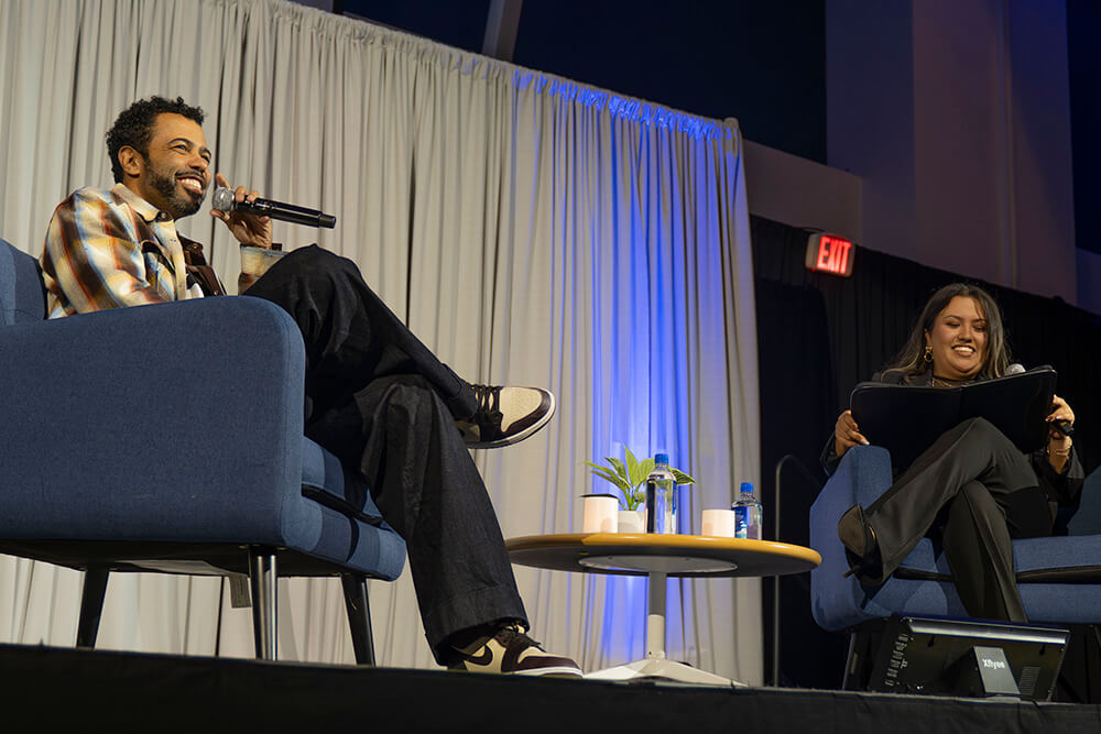 Daveed Diggs and student moderator Tanya Gonzalez sit on stage in CSUF's Titan Student Union.