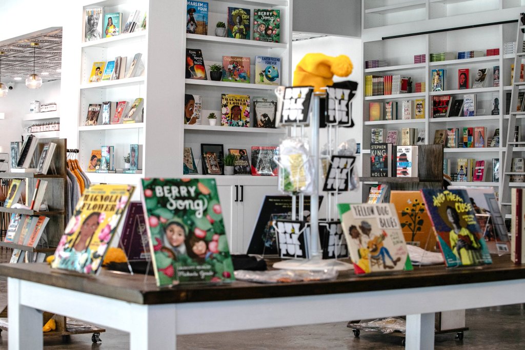 The inside of Fulton Street Books & Coffee filled with books and merchandise