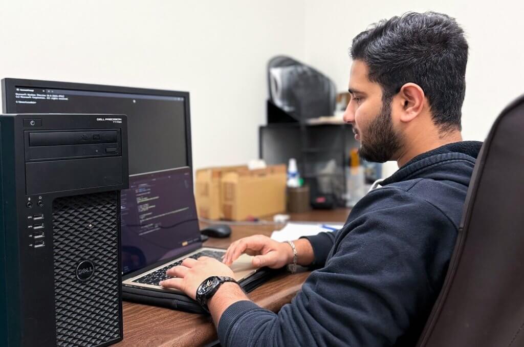 computer science graduate student Asad Abdul at a computer 