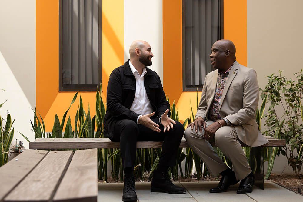 CSUF student Anthony Attalla talks with Austin Nation, associate professor of nursing