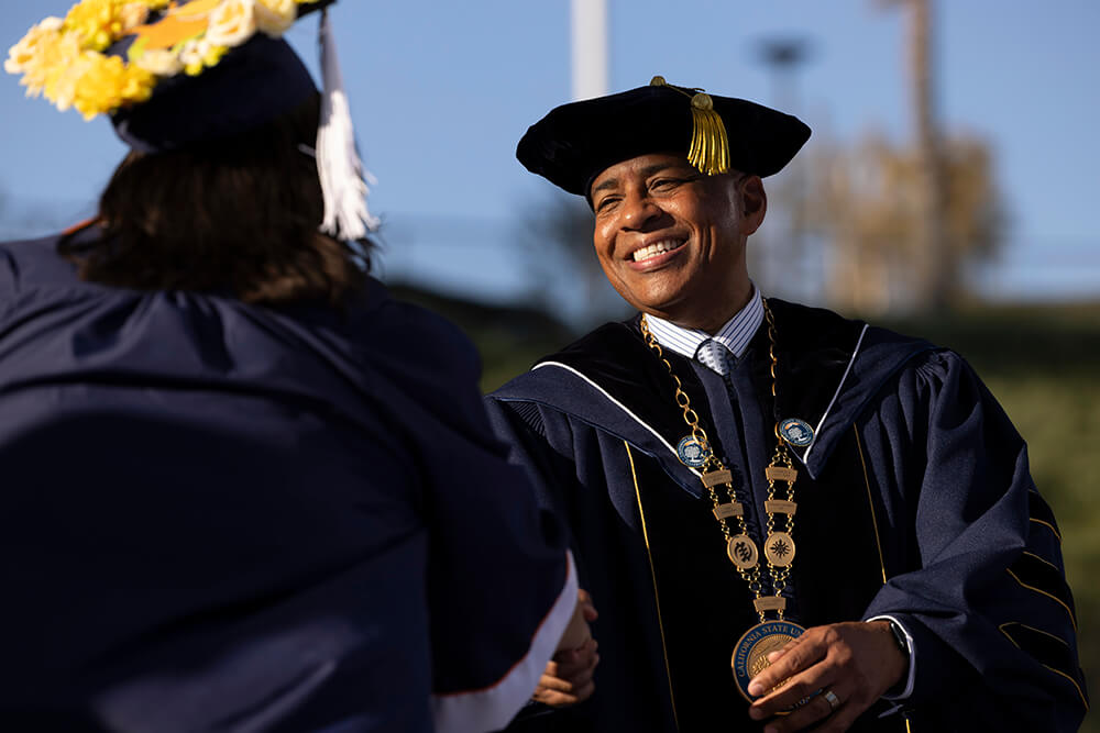 President Rochon congratulates graduate