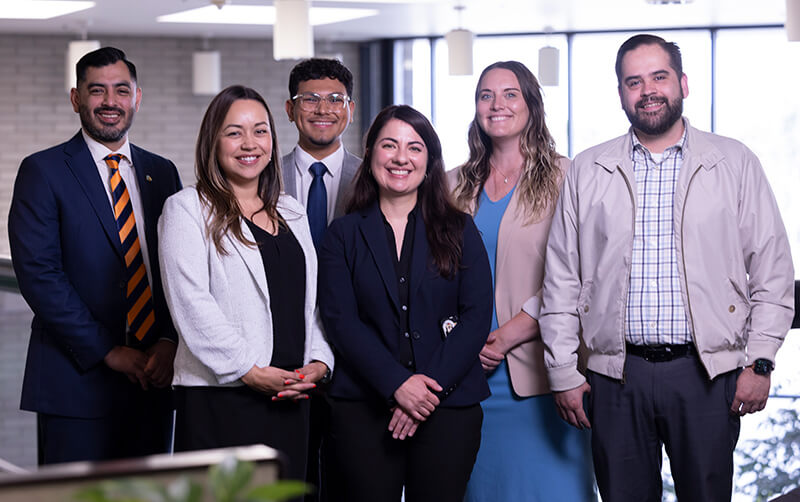 Downey city employees Marlon Ramirez, Juddy Montenegro, Axel Beltran-Perez, Vaniah De Rojas, Shantae Duren, Agustín Estrada pose at City Hall.