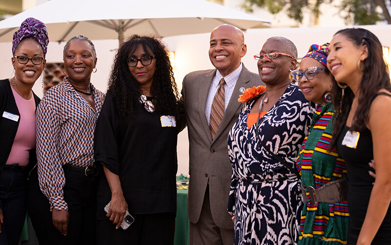 A group of smiling AARC leaders at the Golleher Alumni House