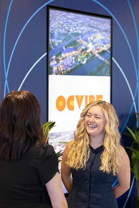 Cal State Fullerton alum Gillian Frey laughs during a conversation with an OCVIBE colleague.