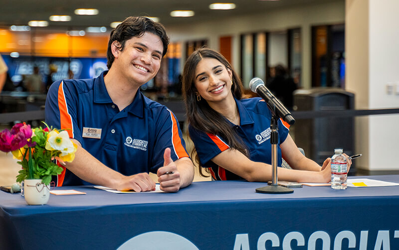 Two ASI students sit at a table in the Titan Student Union.