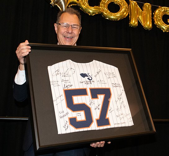 Provost and IT leader Amir Dabirian's holds framed signed jersey