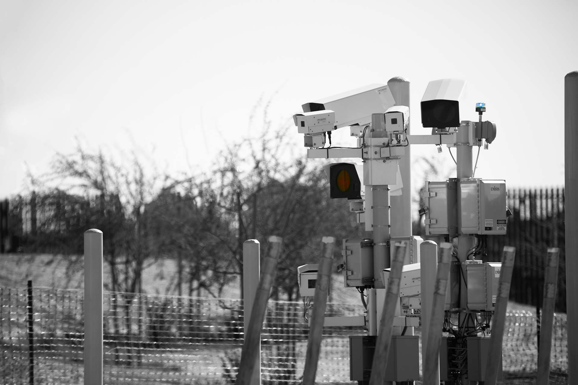 Security cameras and sensors at border fence