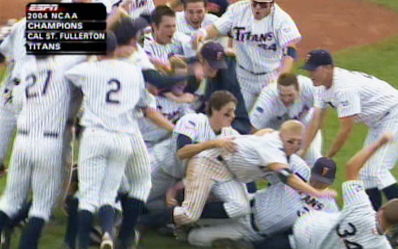 Baseball players celebrating win with a dogpile.