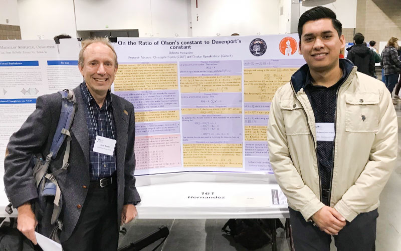 Scott Annin and Roberto Hernandez standing in front of their Olson's and Davenport's Constant research paper.