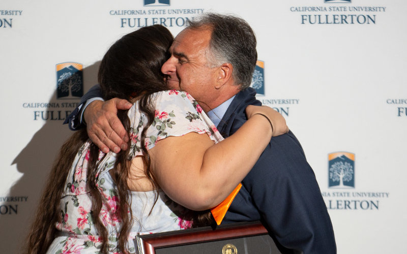 Christina Bennyworth hugs President Virjee