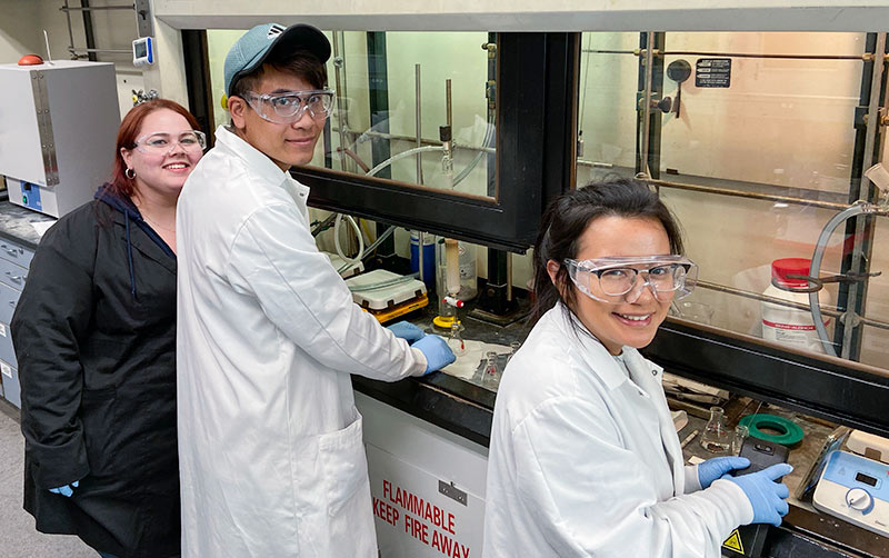 Students research COVID-19 in a lab.