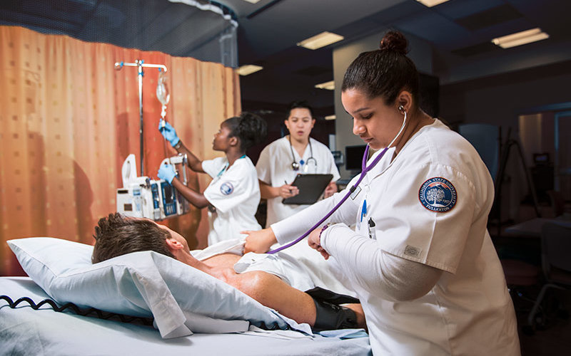 Nurses work in simulation lab.