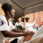 CSUF Nursing students working in simulation lab.
