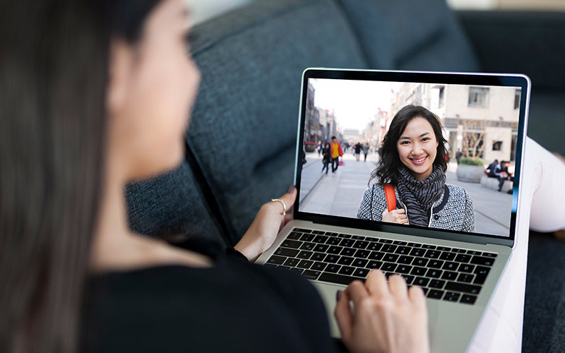 Student with laptop studying abroad virtually learning Korean.