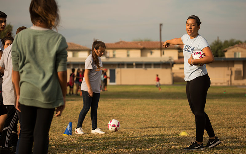 Student leads soccer exercise routine.