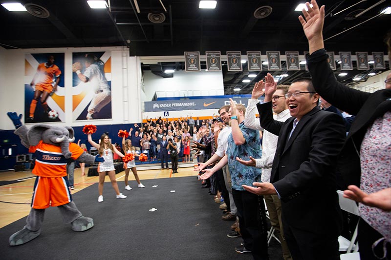 Staff & Faculty learning the Titan Clap with Tuffy