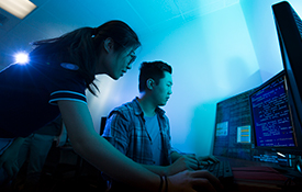 Yu Liu, left, and Daniel Kim work on a cybersecurity project for the Boeing Co.