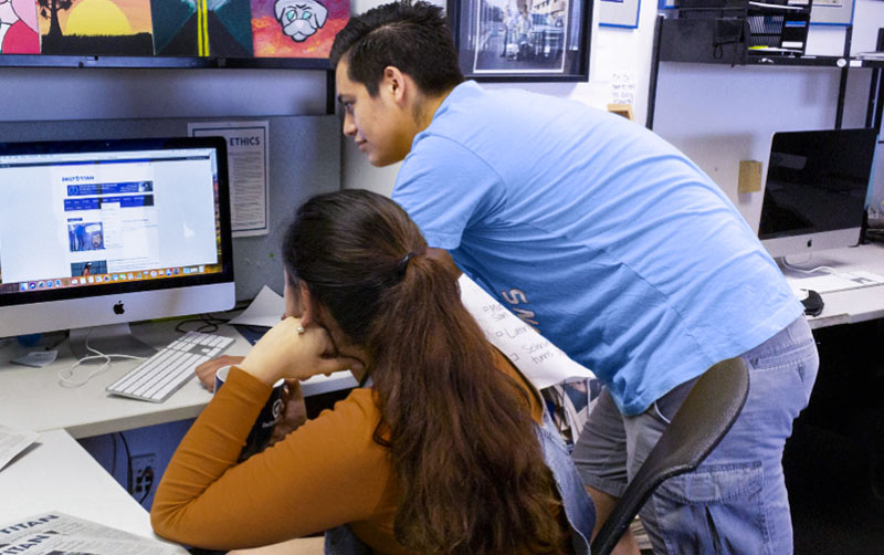 Students work at the Daily Titan