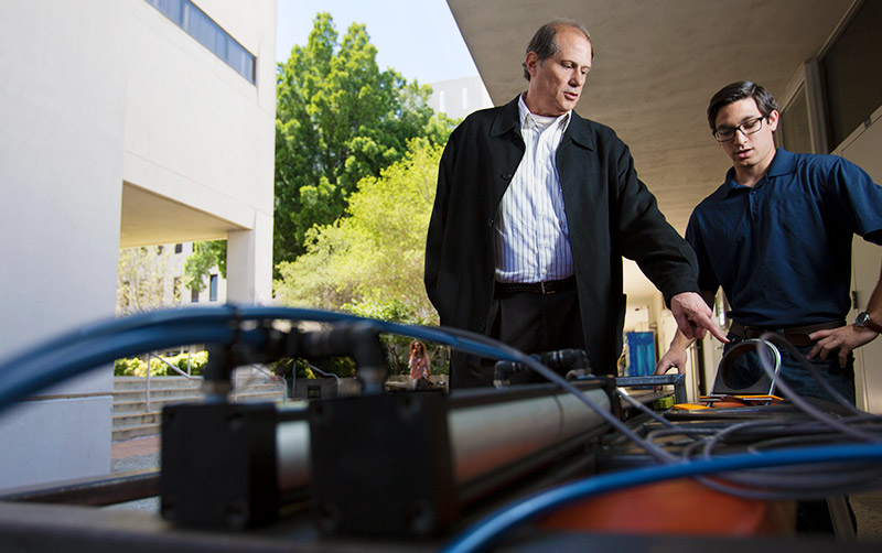 Alum Darrell Jodoin works with a student on his project.