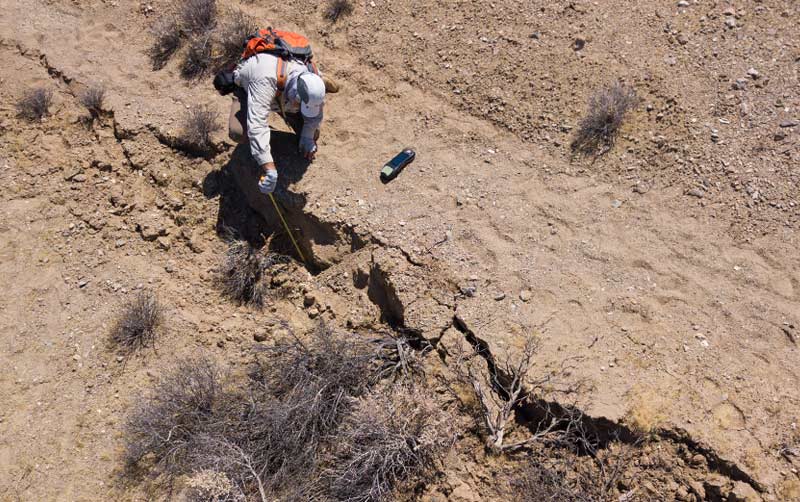Earthquake researcher Sinan Açkiz studies a surface rupture.