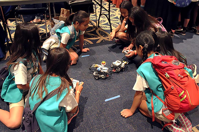GIrl scouts observing robots.