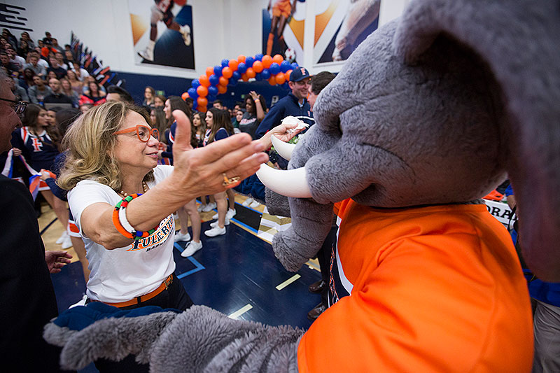 President Mildred Garcia greeting Tuffy at Homecoming.