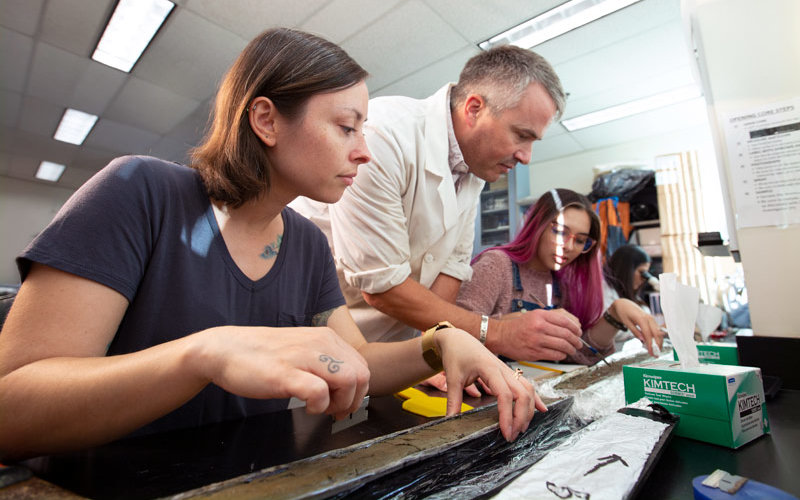 Professor Matthew E. Kirby works with students on paleoclimate research.