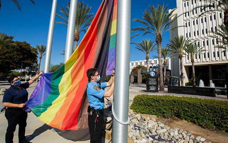 LGBTQ flag raises on campus.
