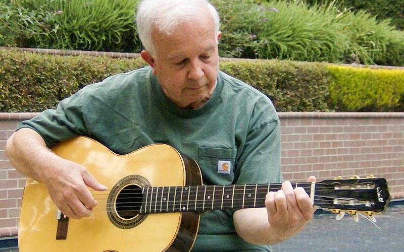 Lawrence Weill playing guitar.