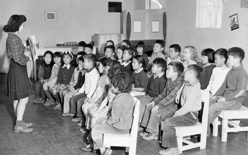 Students with teacher in Manzanar library.