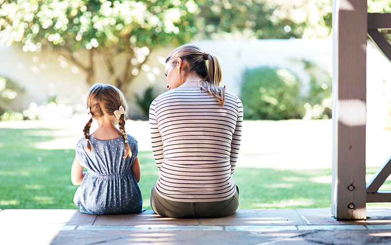 Mother discussing COVID-19 with child.
