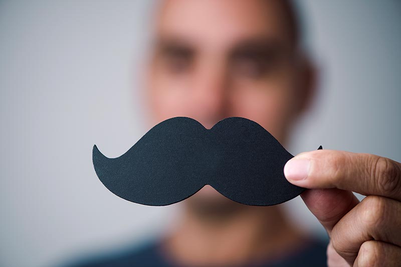 Young man with a fake mustache.