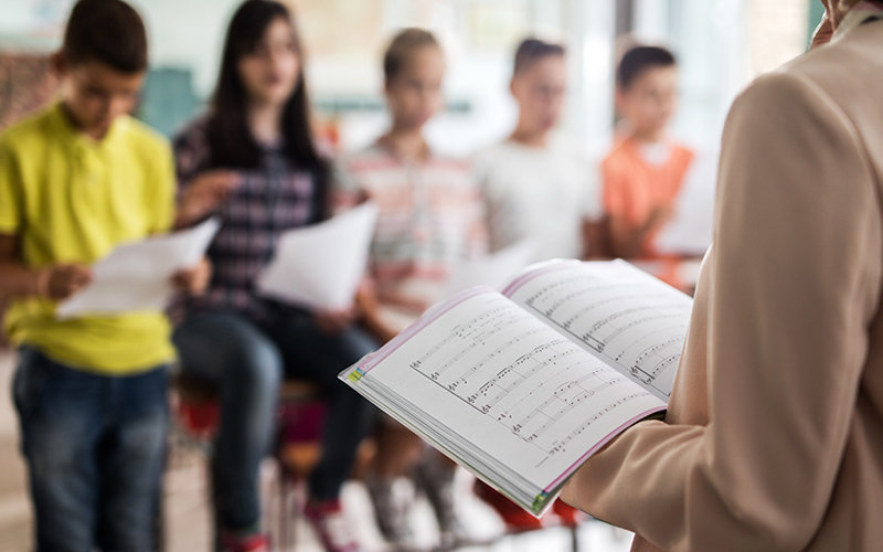 Music teacher in school room.