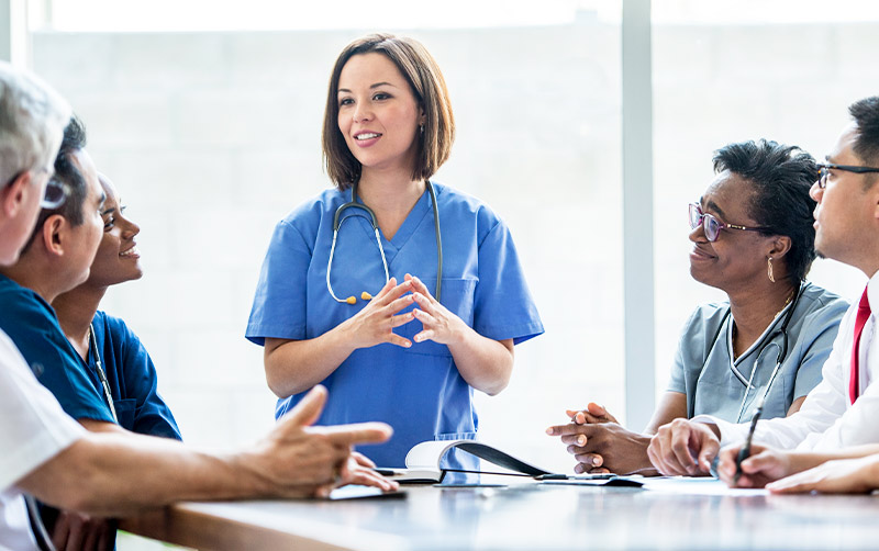 Nurse works with large group.