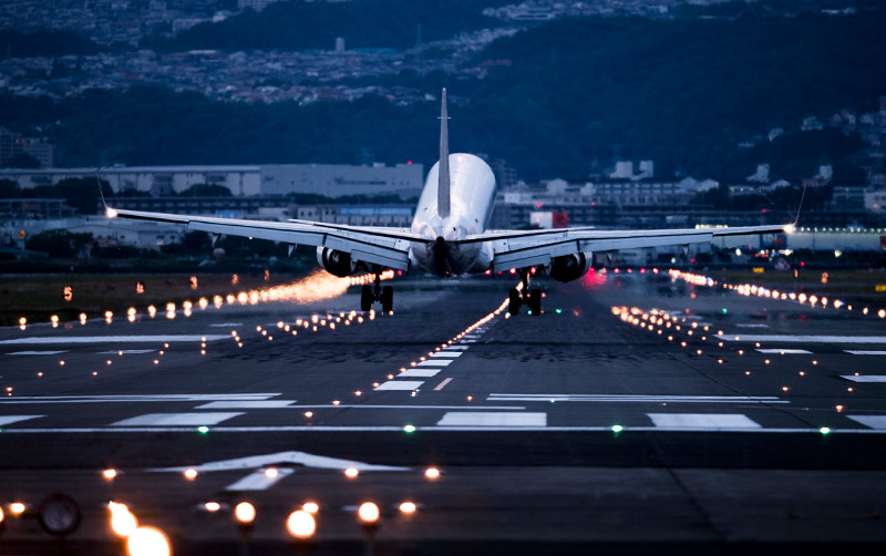 A plane lands at an airport.