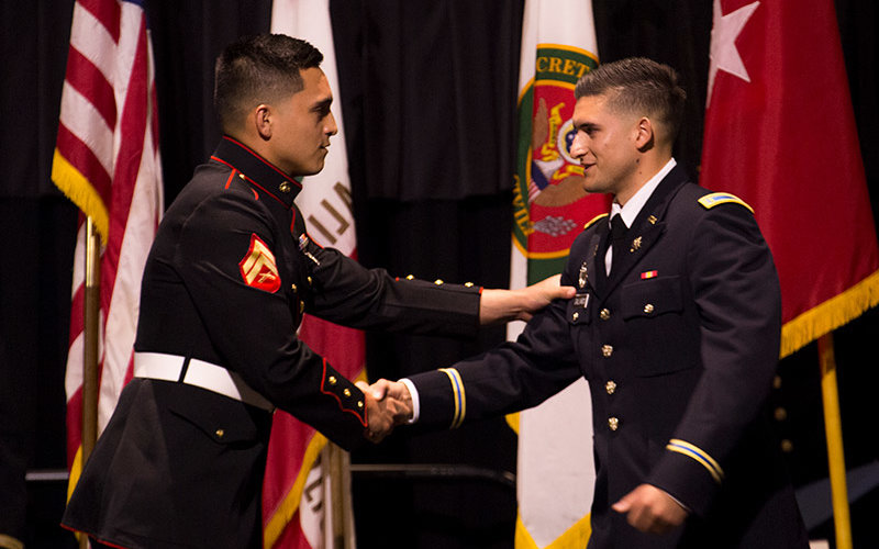 ROTC cadet shakes hands with a friend
